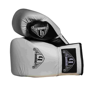 The Hatton Boxing Lace Up Gloves from Hatton, crafted in white and black leather, feature intricate shield and wings logo designs on the wrist. These gloves are perfect for sparring, displayed to show both front and thumb sides.