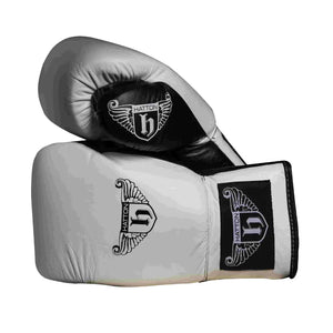 The Hatton Boxing Lace Up Gloves from Hatton, crafted in white and black leather, feature intricate shield and wings logo designs on the wrist. These gloves are perfect for sparring, displayed to show both front and thumb sides.