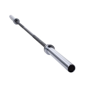 A close-up of the Attack Fitness Olympic 7ft Bar’s end cap shows “20” and Tactical/Strike text around a crosshair. The Cerakote Black finish is visible as the bar, 1500lb tested, angles away on a white background.